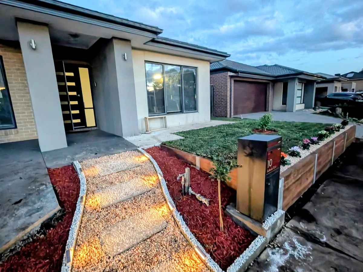 Instant turf and planter beds with garden lighting at dusk