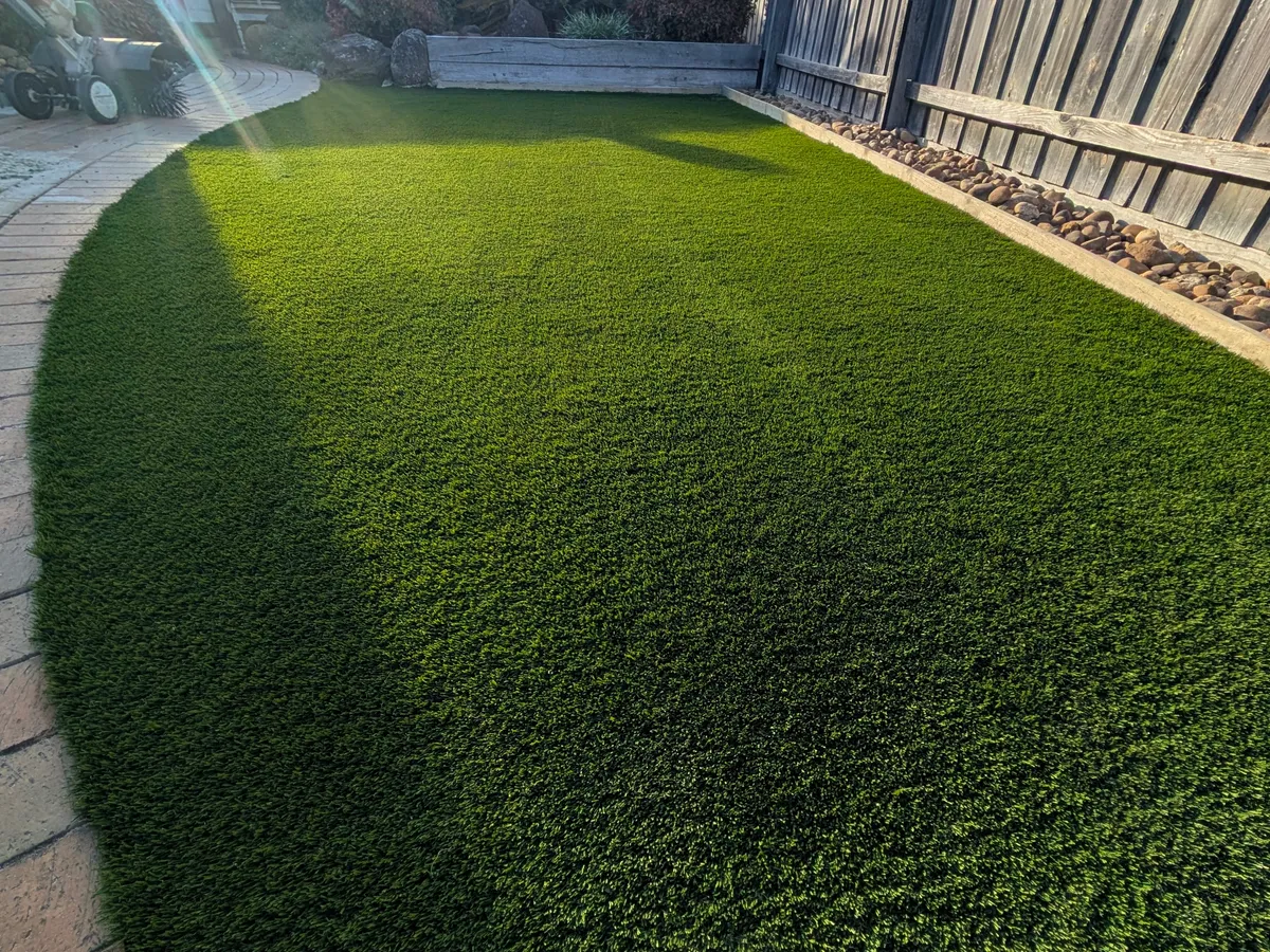 Close view of a finished synthetic lawn's natural-looking pile